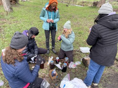 A group practices ancestral skills at the ancestral skills gathering at Ollin Farms