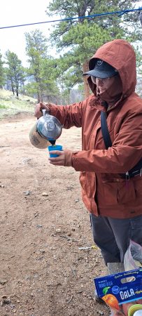 Angevine Middle School day trip participant staying warm with a warm beverage