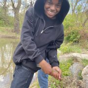 AXL Academy student holding a fish they caught