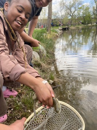 AXL Academy student holding a fish they caught