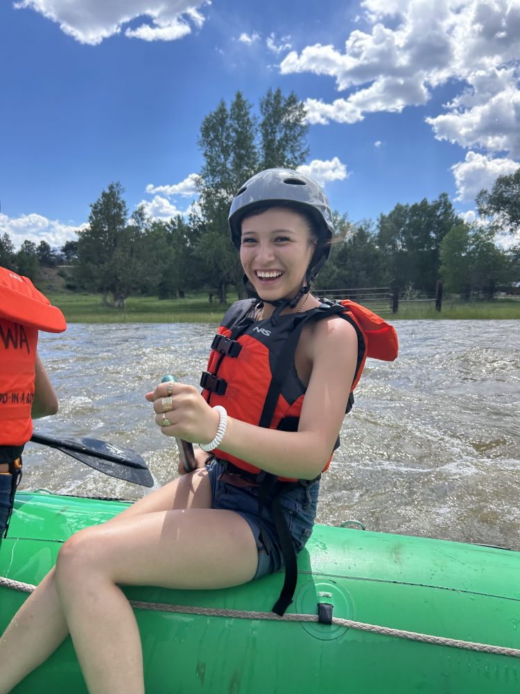 A RiseUp Community High School student rafting on the Arkansas River during the Watershed Project trip