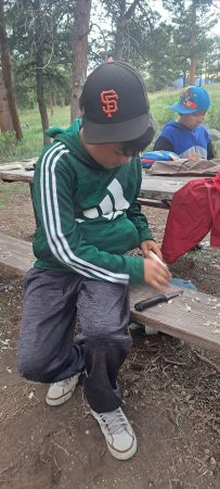 A student whittling at camp