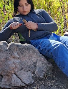 An AXL student whittling