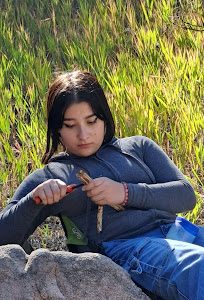 An AXL student whittling