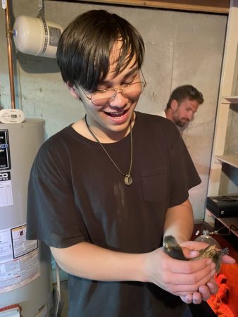 Alum Jesse smiling and holding an animal