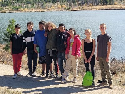 Students share passion related to the outdoors, and in this photo they stand together by a lake.