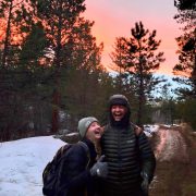 Two alums enjoy a laugh along the trail on the solstice hike.