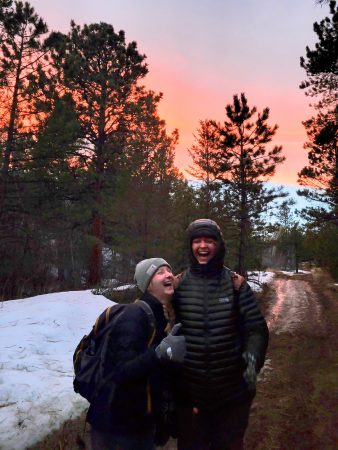 Two alums enjoying a laugh along the trail on the solstice hike.