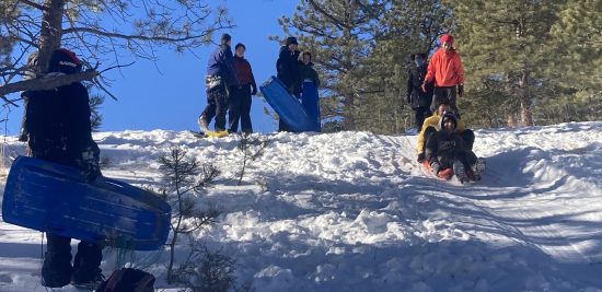 AXL Academy students enjoy the thrill of sledding during their overnight trip to Cal-Wood.