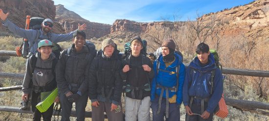 One group of Peak to Peak backpackers smiles for the camera during their backpacking adventure in Dominguez Canyon.